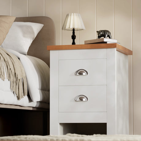 White shaker chest of drawers with brushed cup handles and oak-effect top near bed from white bedroom furniture sets