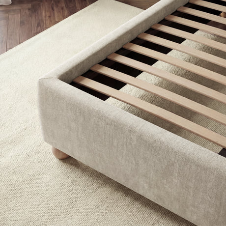 Velvet beige upholstered king bed frame featuring sturdy wooden slats for mattress support