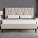 Beige upholstered bed with diamond patterned headboard in a room setting.