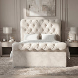 [Beige] Straight bedroom view with tufted headboard and footboard, matching side tables, lamps, and wall art