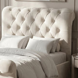 [Beige] Close view of tufted headboard with button detailing, white pillows, bedding, and rounded side bolster