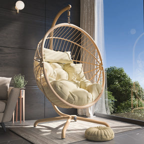 Wicker egg chair with beige cushions in a modern room with a window view.