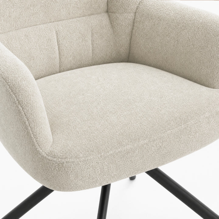 [Beige | Set of 4] Dining chair close-up of boucle seat, curved arm & stitched multi-panel back, with black metal legs below.