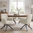 [Beige | Set of 4] Four swivel dining room chairs around a pale wood table styled with a bowl & vase in a bright dining room.