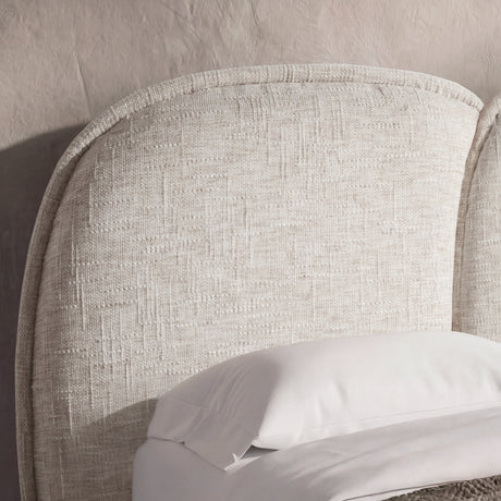 [King | Beige] Upholstered bed frame with a soft padded headboard and wooden legs in a soft light bedroom setting