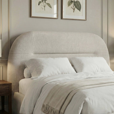 Detailed view of the headboard of the beige upholstered king-size bed frame with white bedding
