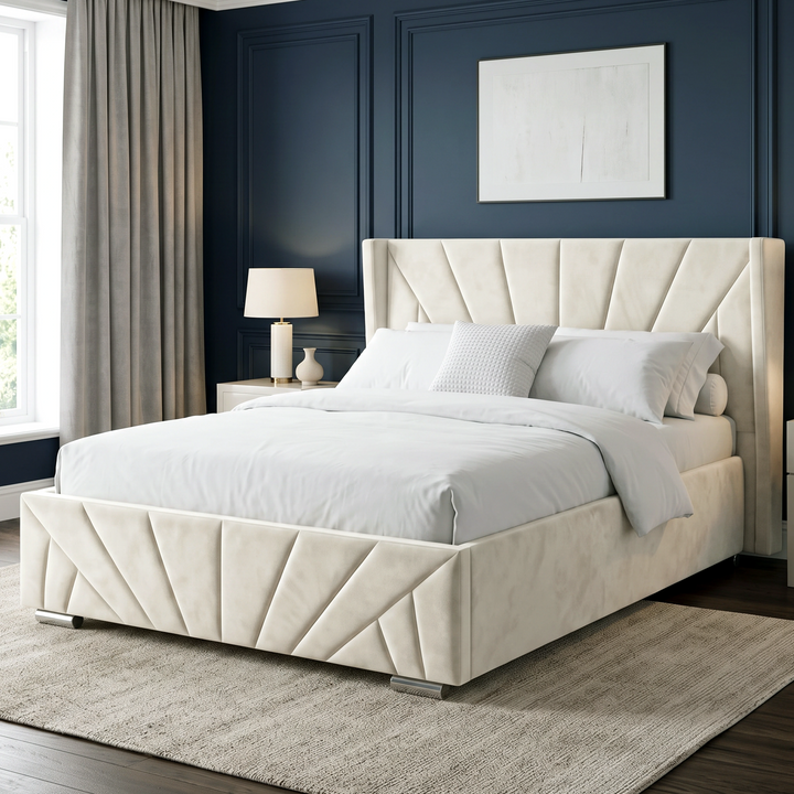 [King | Beige] Angled main view of the Sunrise King Ottoman Storage Bed Frame Beige Velvet styled on a light rug against a dark blue wall.