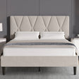 Beige upholstered bed with diamond patterned headboard in a room setting.