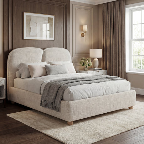 Beige upholstered double bed frame with a soft fabric finish, complemented by simple bedding and a cozy bedroom setting