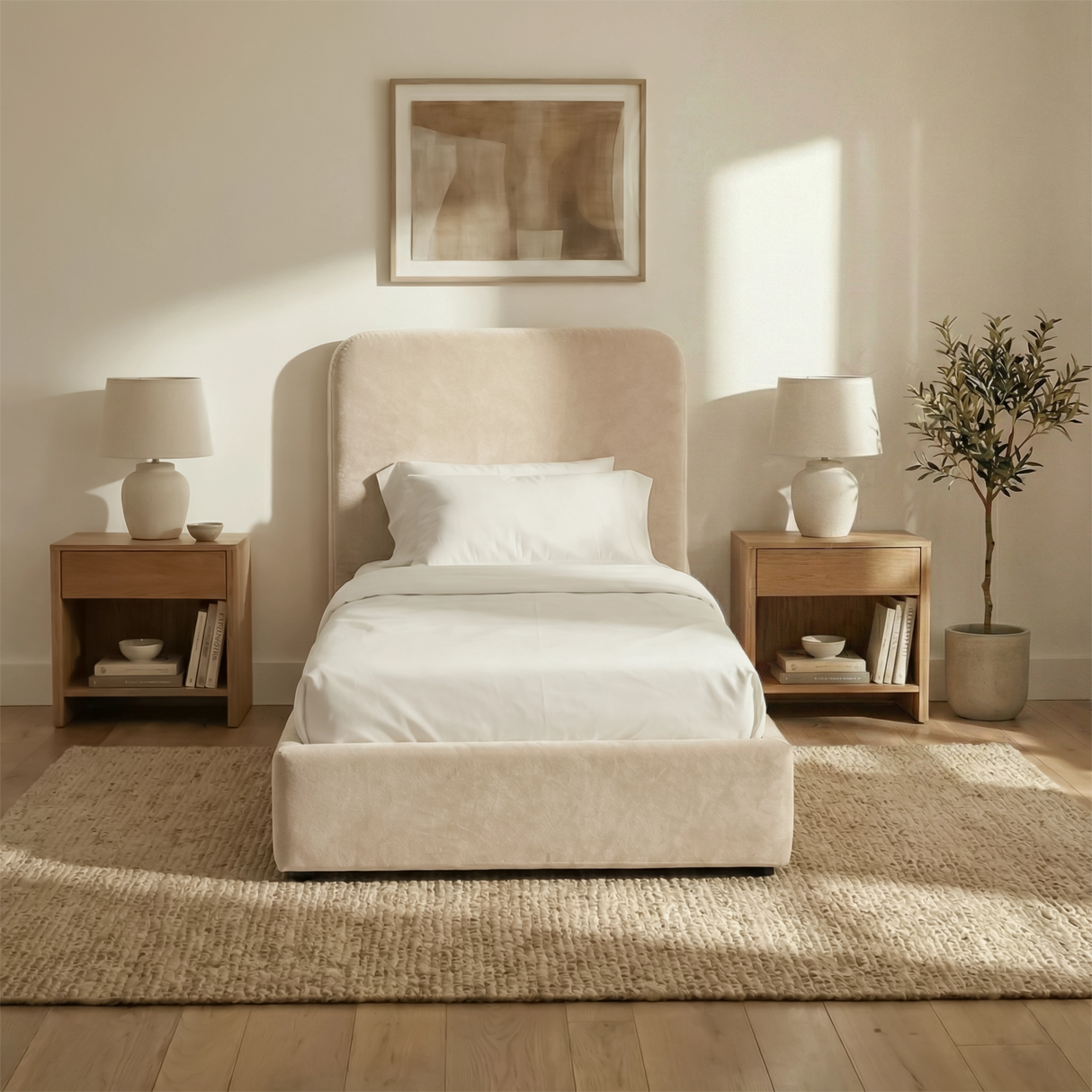 Front view of beige velvet single ottoman storage bed centred between bedside tables in a light neutral interior