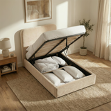 Single beige velvet ottoman bed lifted to reveal under-bed storage compartment with mattress support frame