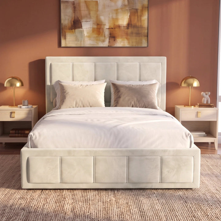 [Small Double | Beige] Front-on view of velvet ottoman storage bed centred between bedside lamps under framed wall art