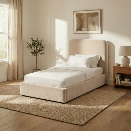 Angled view of beige velvet single ottoman bed showing upholstered frame, curved headboard, and low base design