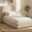 Beige velvet single ottoman storage bed with curved upholstered headboard displayed in styled room with neutral decor
