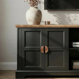 [Black] Bellford TV unit close-up of copper half-moon handle fixed to the shaker door panel, oak top above