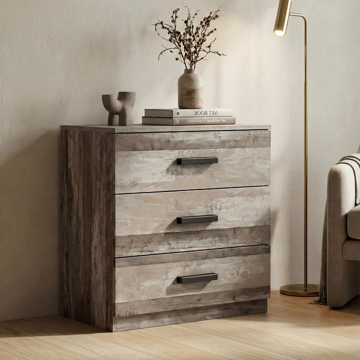 [Ash Grey] three drawer chest positioned in room with textured finish and black wooden bar handles