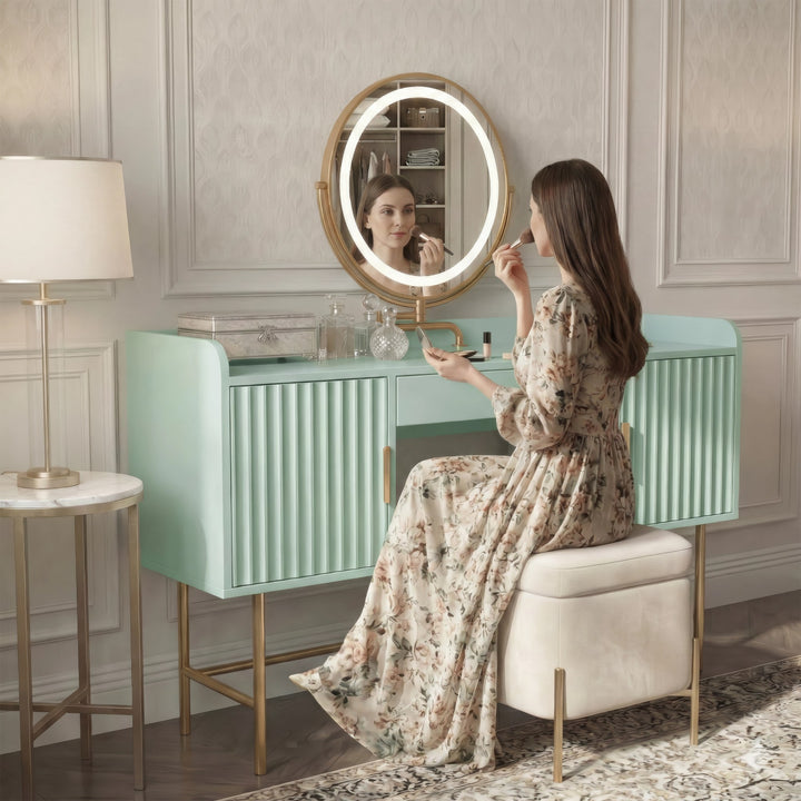 [Sage Green] side-profile lifestyle of the sage green vanity with a person at the lit round mirror and patterned floor