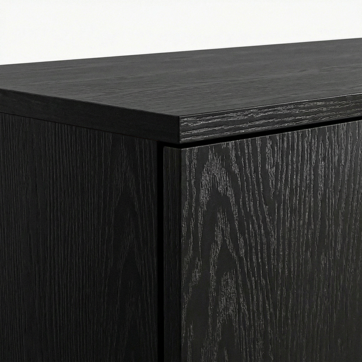 [Black] Top panel corner detail of black wardrobe highlighting surface texture and sharp edges
