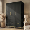 Black three door wardrobe with drawers positioned in room corner beside chair and neutral decor
