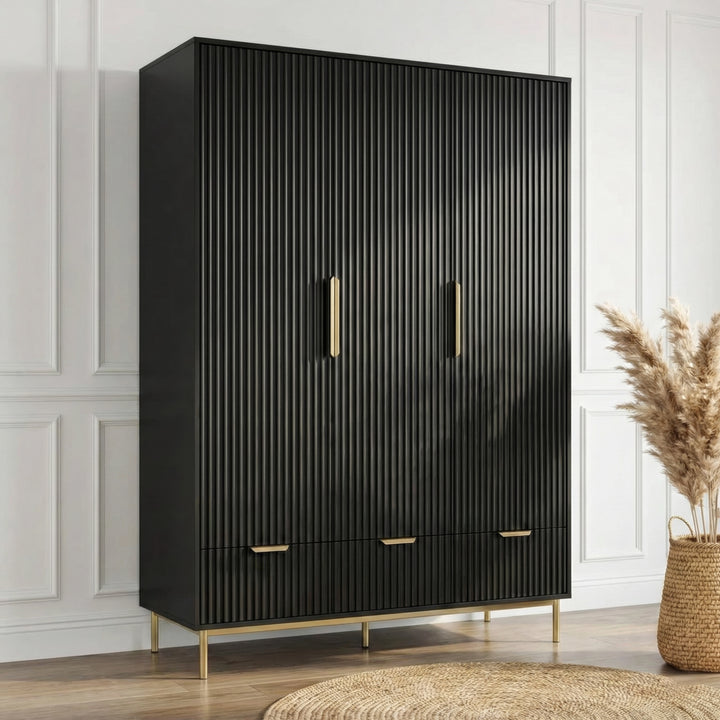 [Black] three door wardrobe with drawers positioned in room center on a wooden flooring