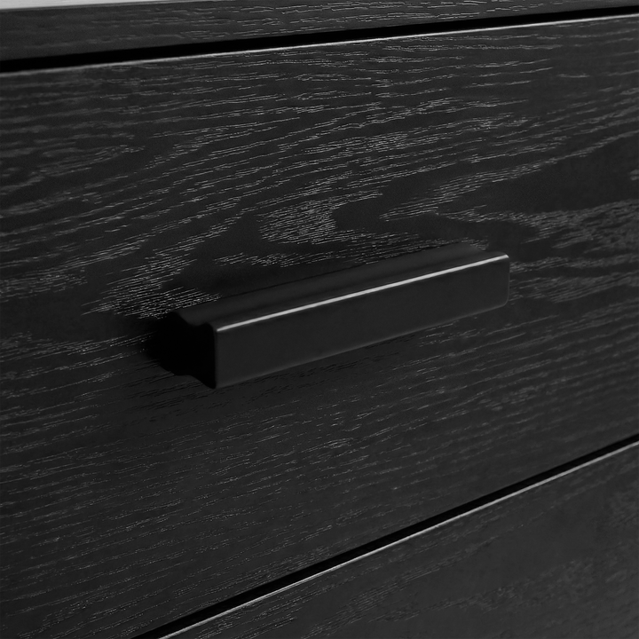 [Black] Close up of black drawer front with black wooden handle detail and visible wood grain texture of chest