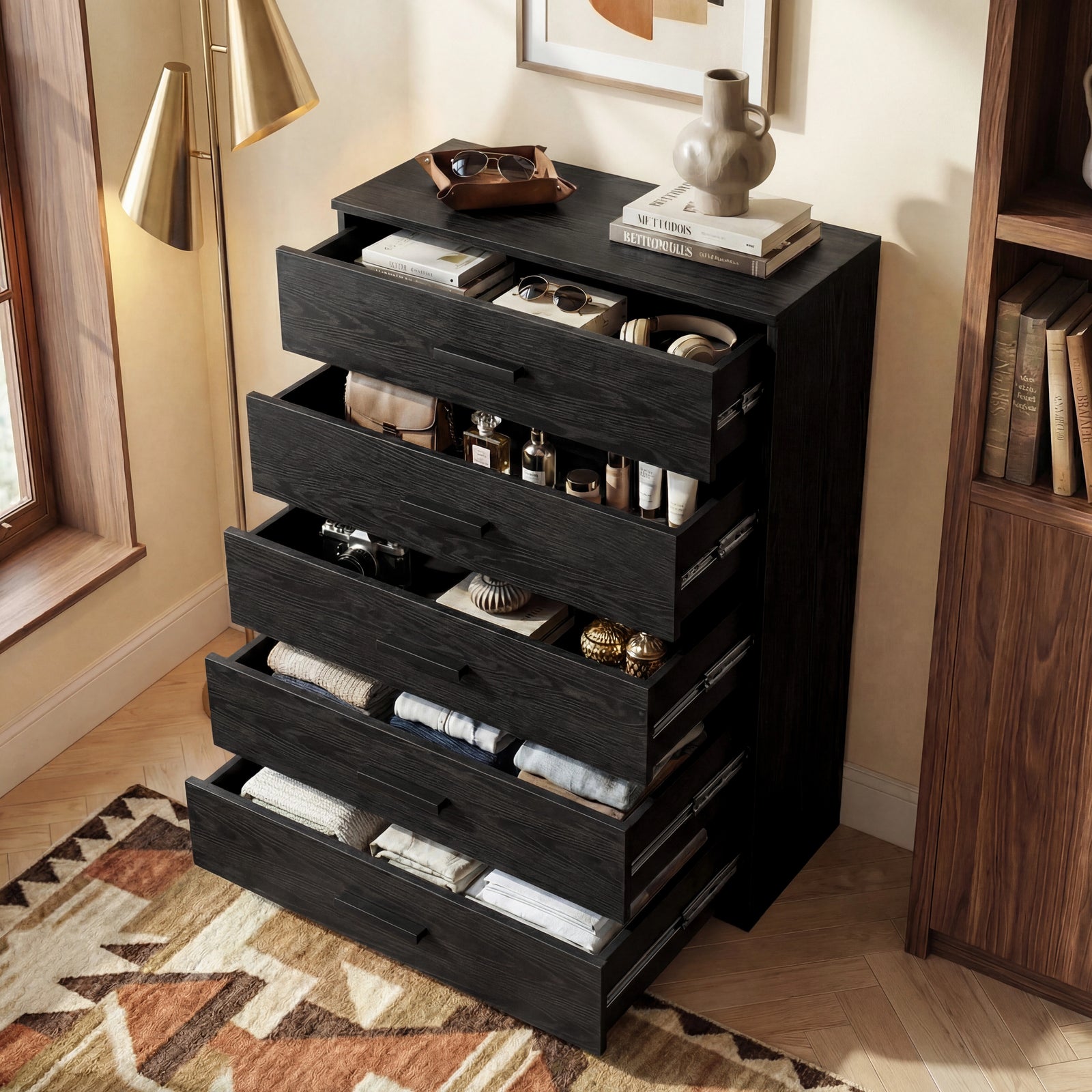[Black] five drawer chest shown at angle with drawers open, revealing storage depth and side runner mechanism