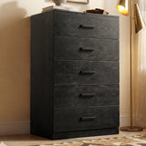 [Black] five drawer chest styled in warm interior with floor lamp, shelving, and black wooden handles
