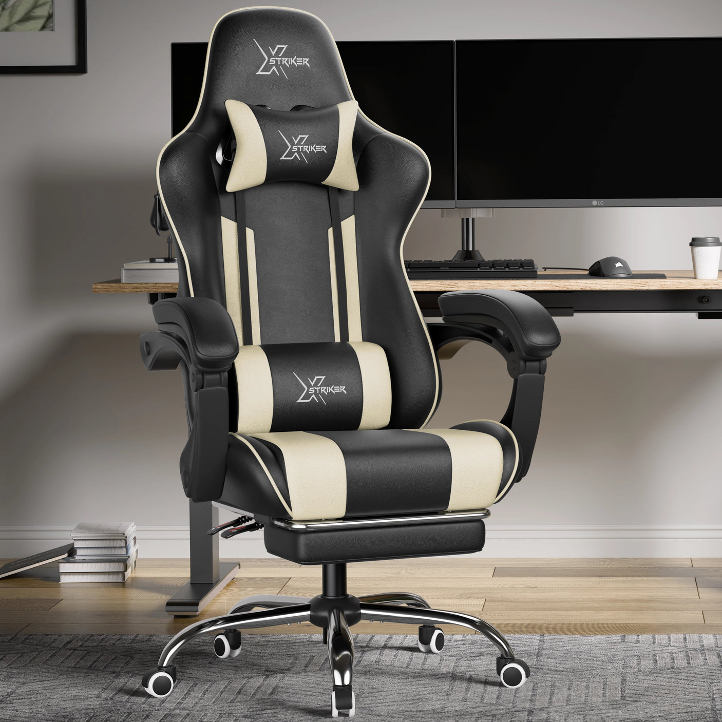 Black and white gaming chair in a modern office setup with a desk and computer monitors.