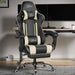 Black and white gaming chair in a modern office setup with a desk and computer monitors.
