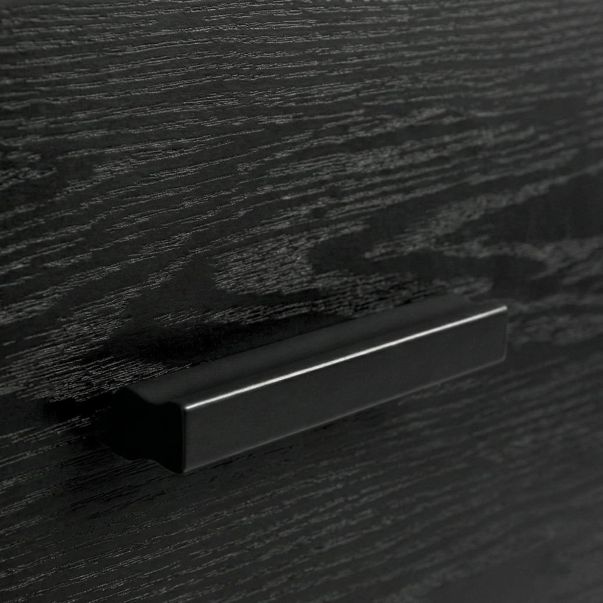 [Black] Close up of black drawer front with integrated handle detail and visible wood grain texture