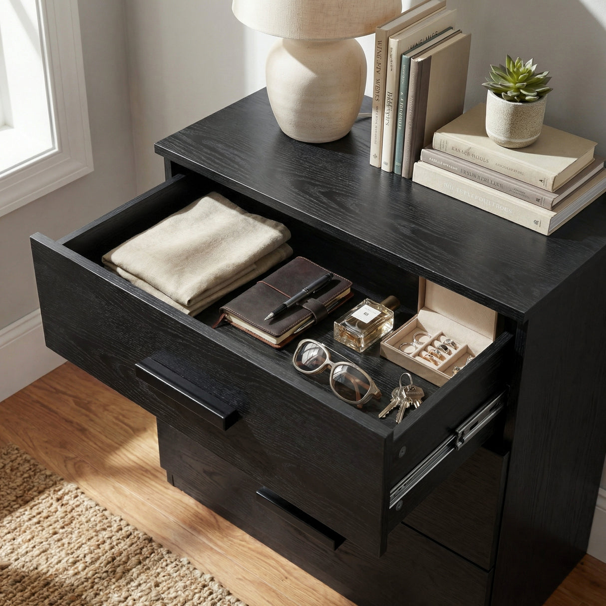 [Black] Close view of black bedroom chest drawer interior showing storage capacity and smooth side runner mechanism