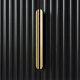 Close detail of a black wardrobe with a vertical golden metal handle against a flutrina door surface