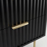 Close detail of the gold metal drawer handle and legs of the black flutrina design bedside table