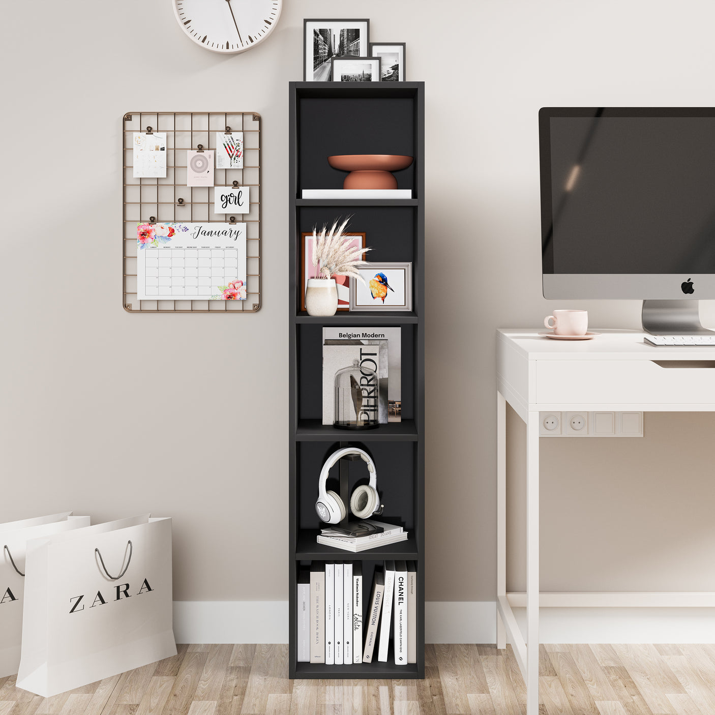 Tall black narrow bookshelf beside a desk, ideal for organizing books and accessories in a stylish workspace.