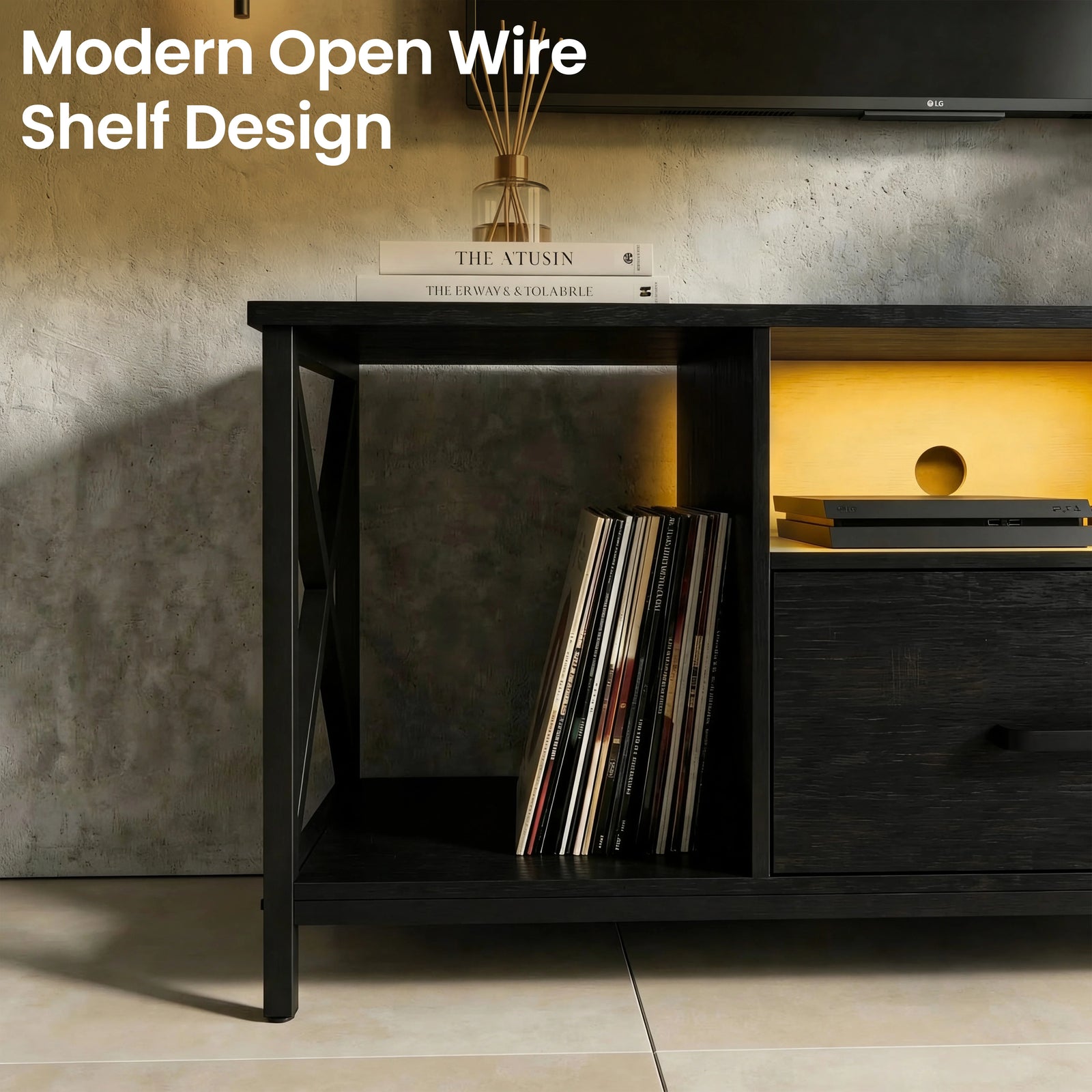 [Black] Calvera TV unit close crop on open wire-shelf cubby lit by amber LED, stacked books on top surface