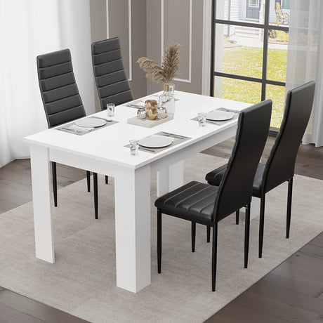 Dining set for 4 with black padded chairs and compact white table, ideal for modern dining rooms or kitchens with limited space.