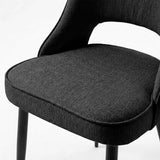 [Black | Set of 4] Comfy dining chair close-up of padded seat, piped edge, curved open back and black metal legs.