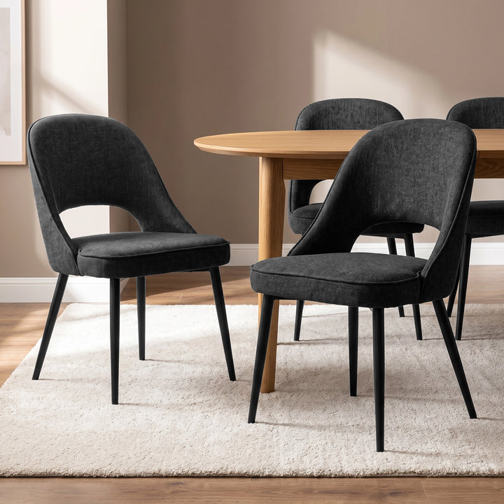 [Black | Set of 4] Four curved-back modern dining chairs with padded seats and black legs styled around a round wood table.