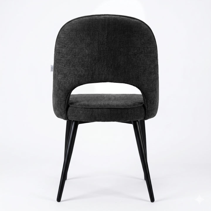 [Black | Set of 4] Rear view of the comfy fabric dining chair with rounded open back, piped seat and four black metal legs.