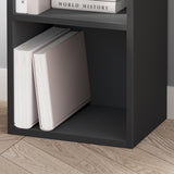 Bottom shelf of black narrow bookshelf with large books, offering sturdy and modern storage.