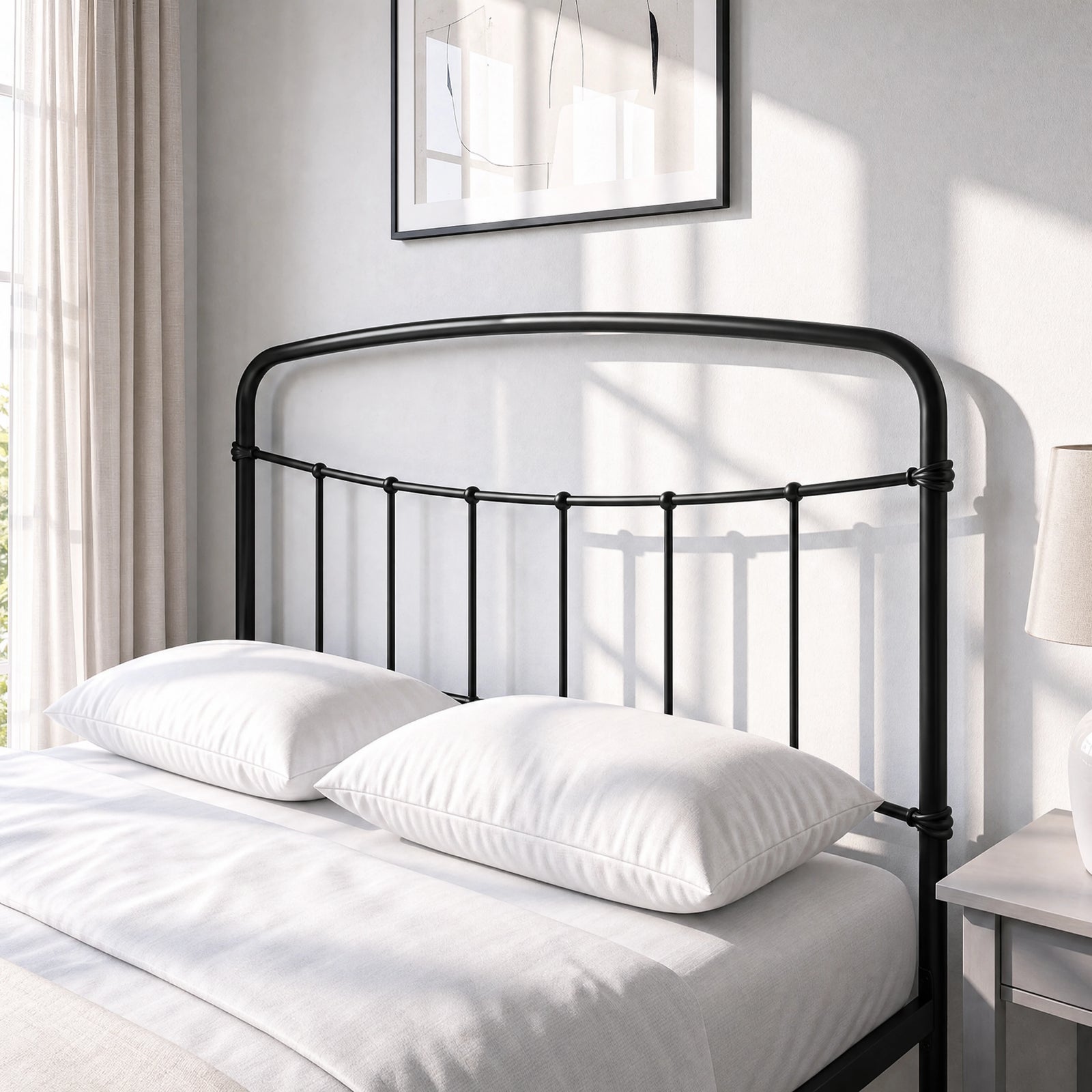 [Black | Double] Close-up of the black curved headboard with vertical bars, white pillows and cream bedding.