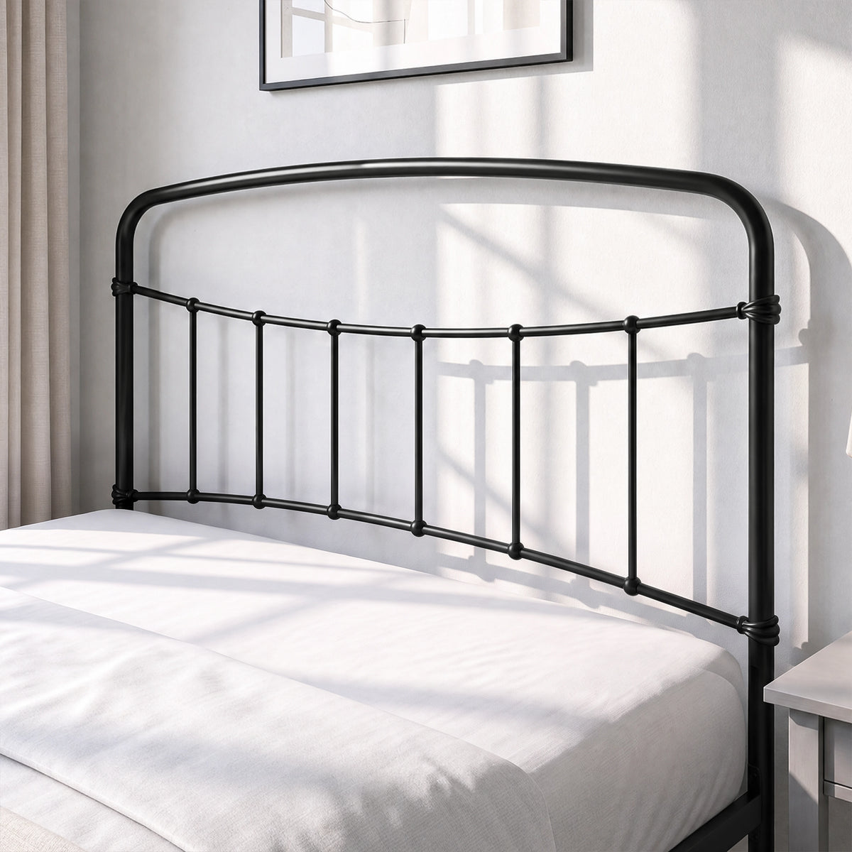 [Black | Double] Close-up of the black curved headboard with vertical bars, white pillows and cream bedding.