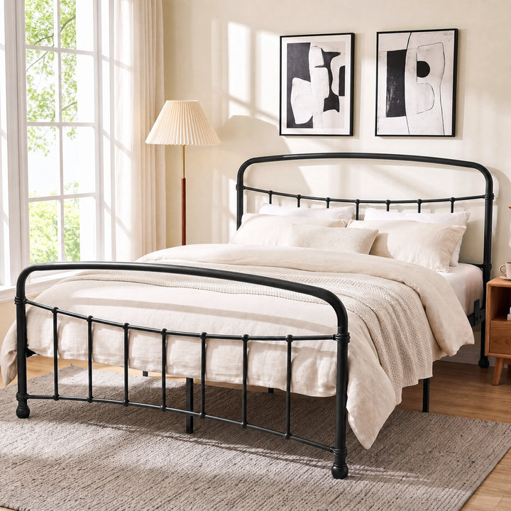 [Black | King] Black metal bed frame with curved rails and cream bedding, shown at a 3/4 Angle in bright bedroom.