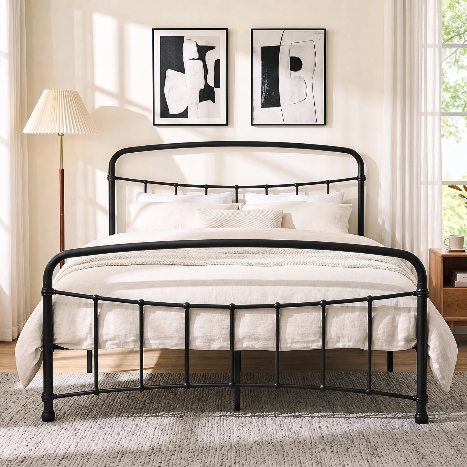[Black | King] Front view of a black metal bed frame with curved rails and cream bedding in a bright bedroom.