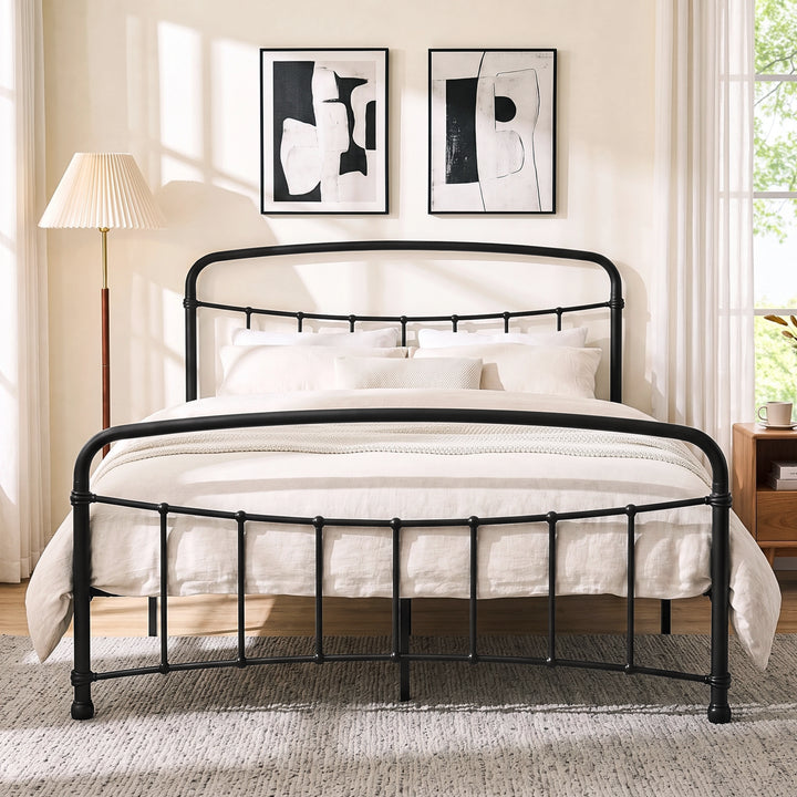 [Black | King] Front view of a black metal bed frame with curved rails and cream bedding in a bright bedroom.