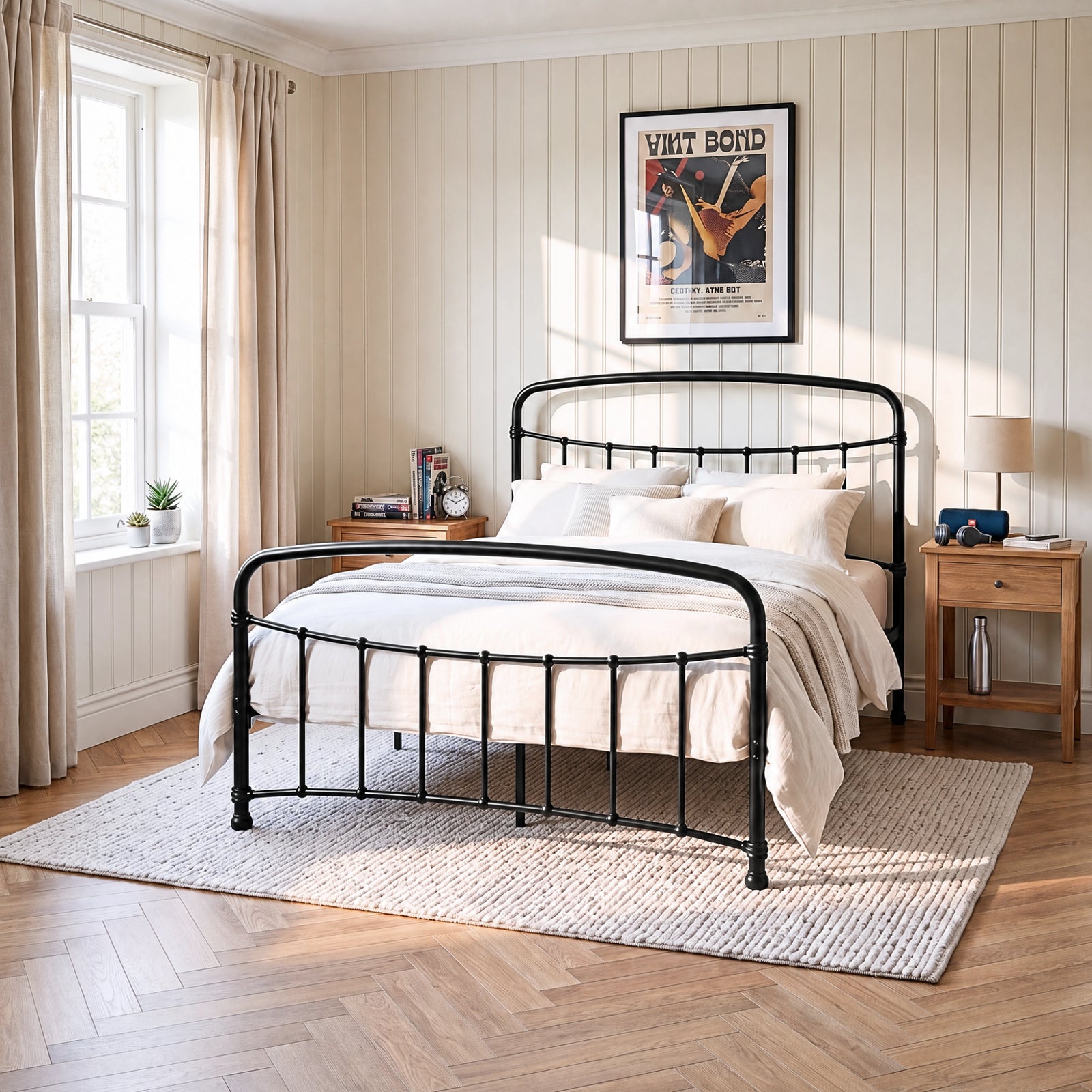 [Black | King] Black metal bed frame with cream bedding, wooden side tables and a woven rug in a bright bedroom.