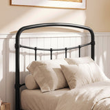[Black | Single] Close-up of the black curved headboard with vertical bars, white pillows and cream bedding.