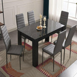 Black dining room table set with stylish design, perfect for modern dining spaces.