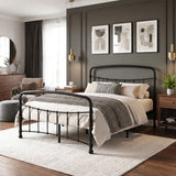 [Black | Double] Wide bedroom view showing curved rails, chunky throw, armchair, footstool, dresser, round mirror, and fern.