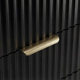 Gold metal handle detail on a black flutrina chest of drawers front with vertical sturdy panel design